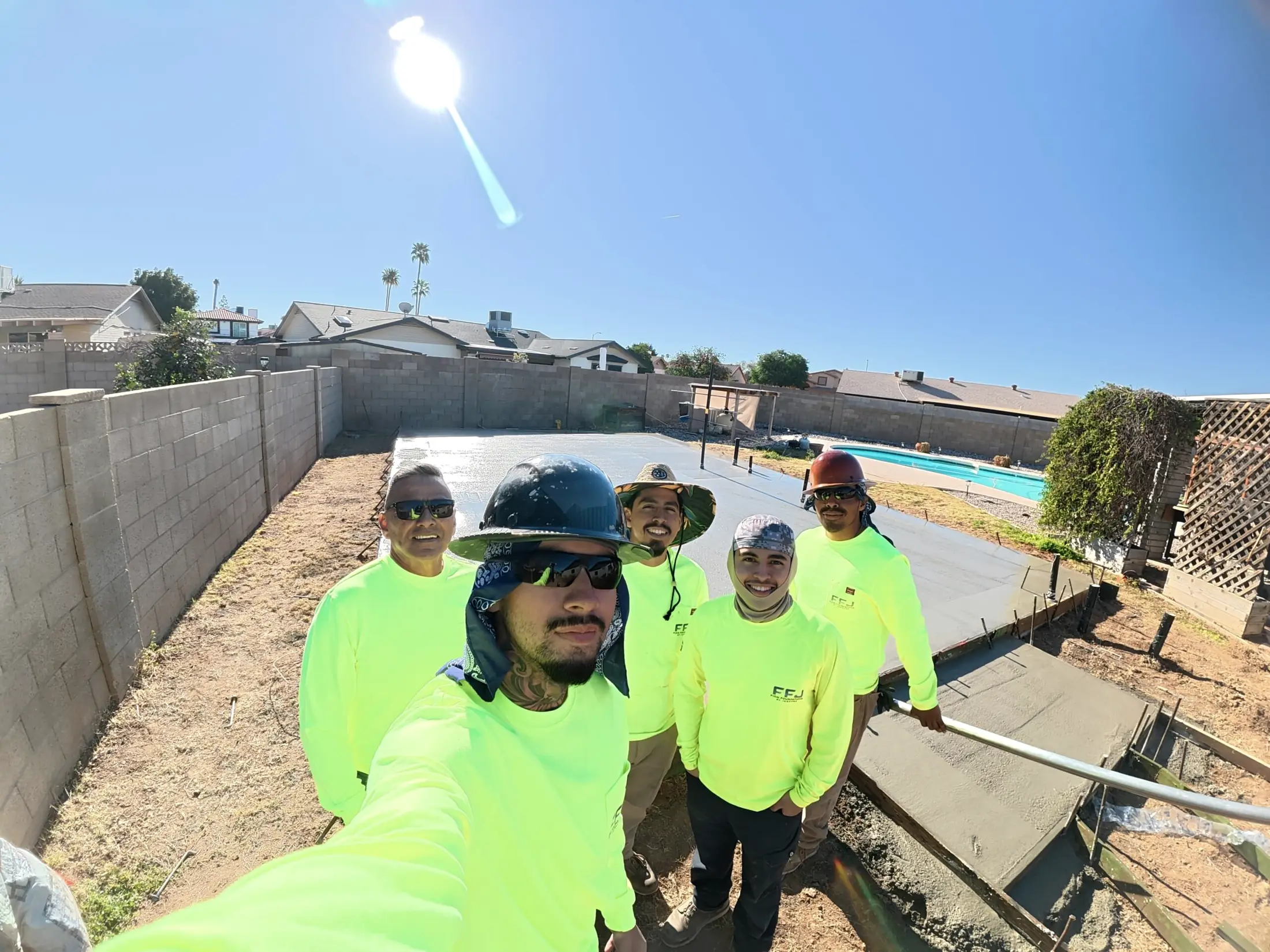 The Firm Foundations crew in hi-vis shirts on a backyard pour