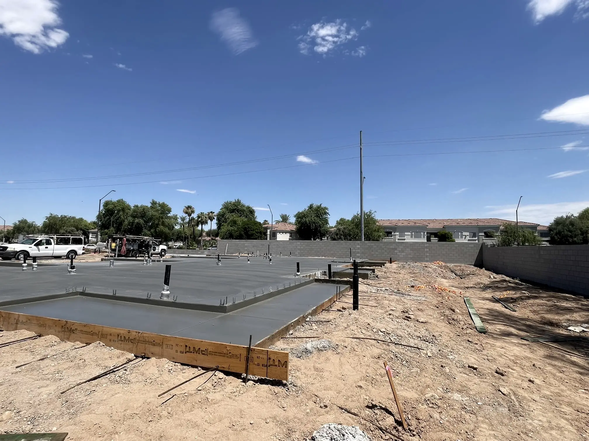 Stem-wall forms and a fresh slab on a new-build lot